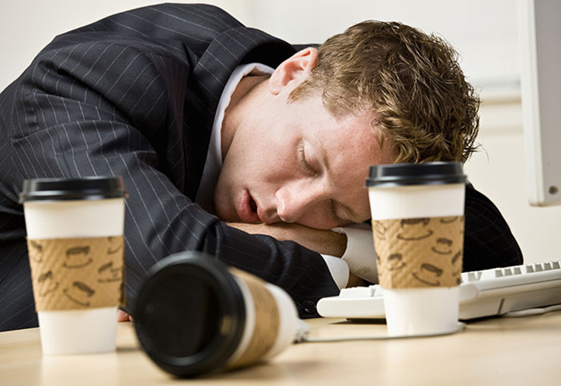 Exhausted Business Man With Empty Coffee cups