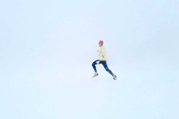 man running in the winter snow