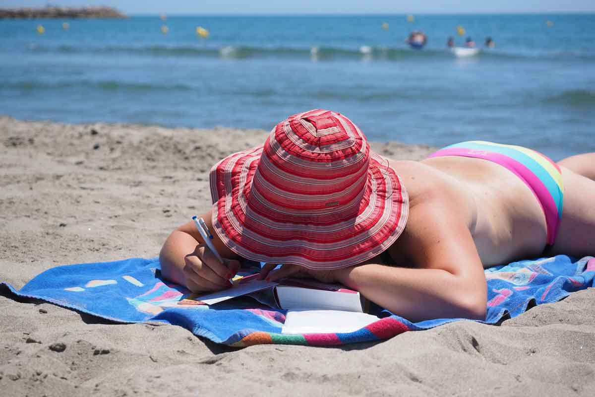 girl sun bathing on the beach