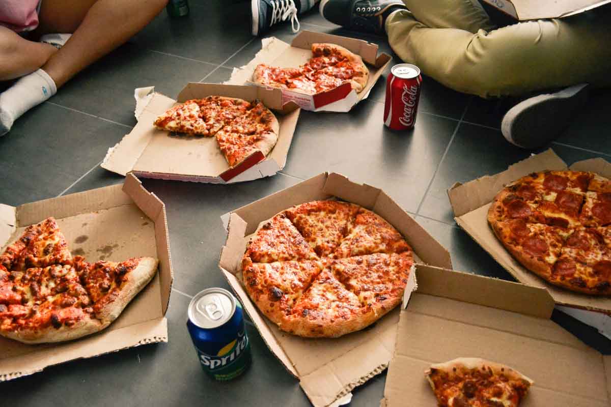 Pizza and soda on floor