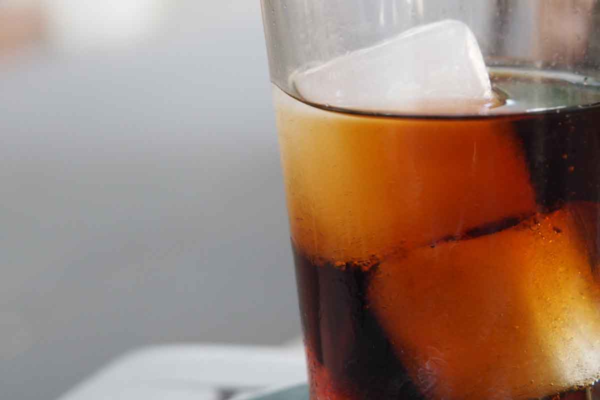 close up of soda in glass with ice