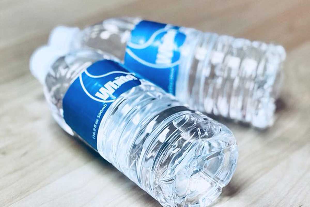 custom labeled bottled water on desk