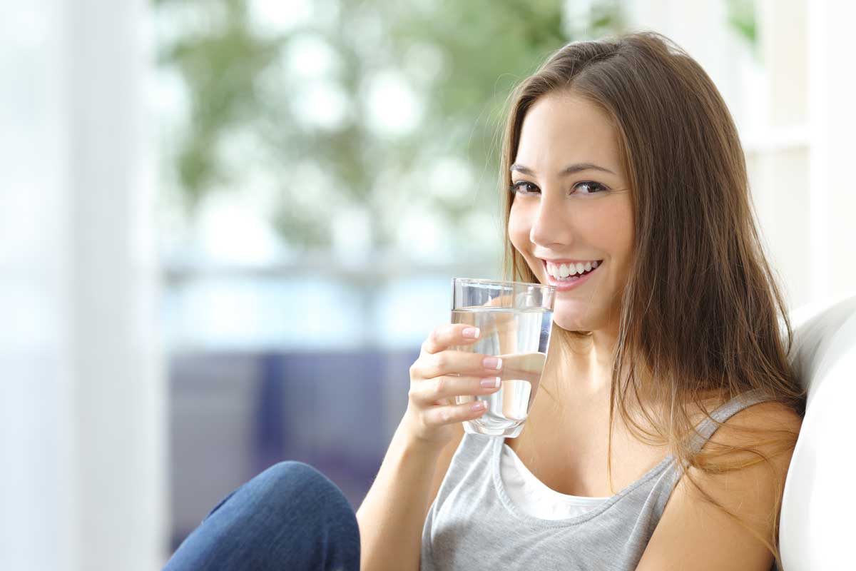 girl drinking clean water softener