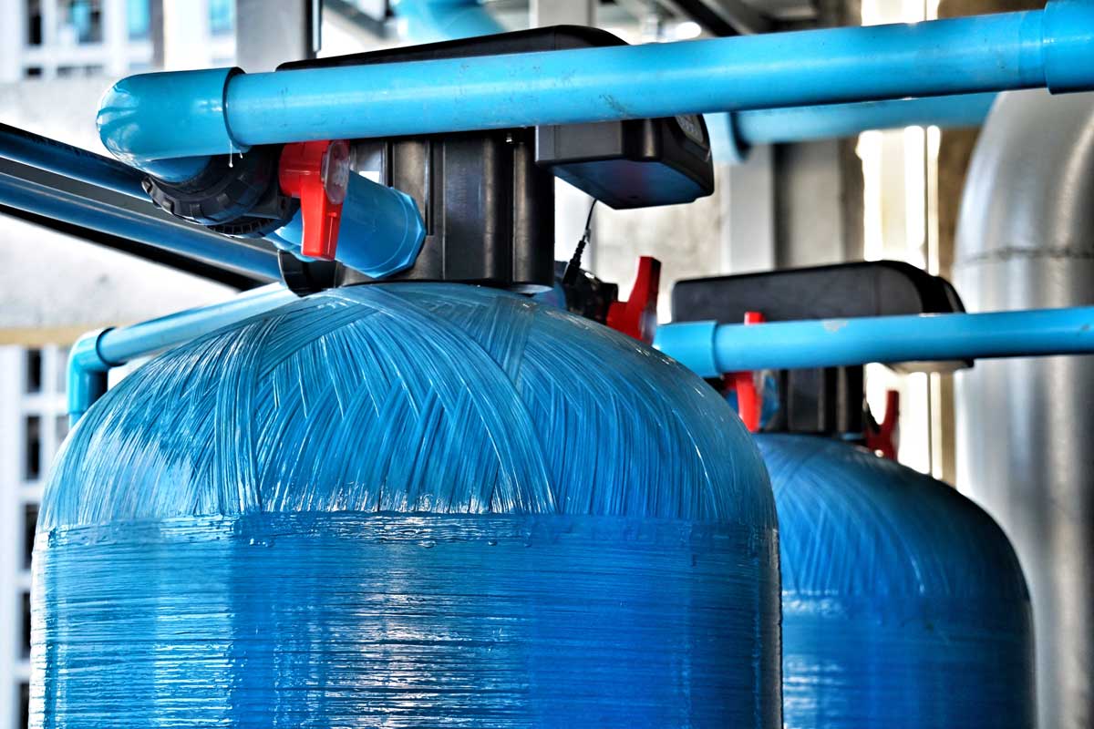 large blue water softening tanks