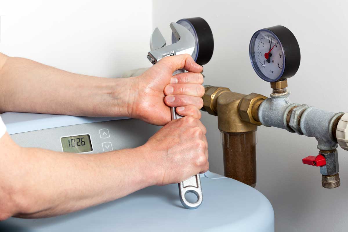 person fixing and doing maintenance on water softener