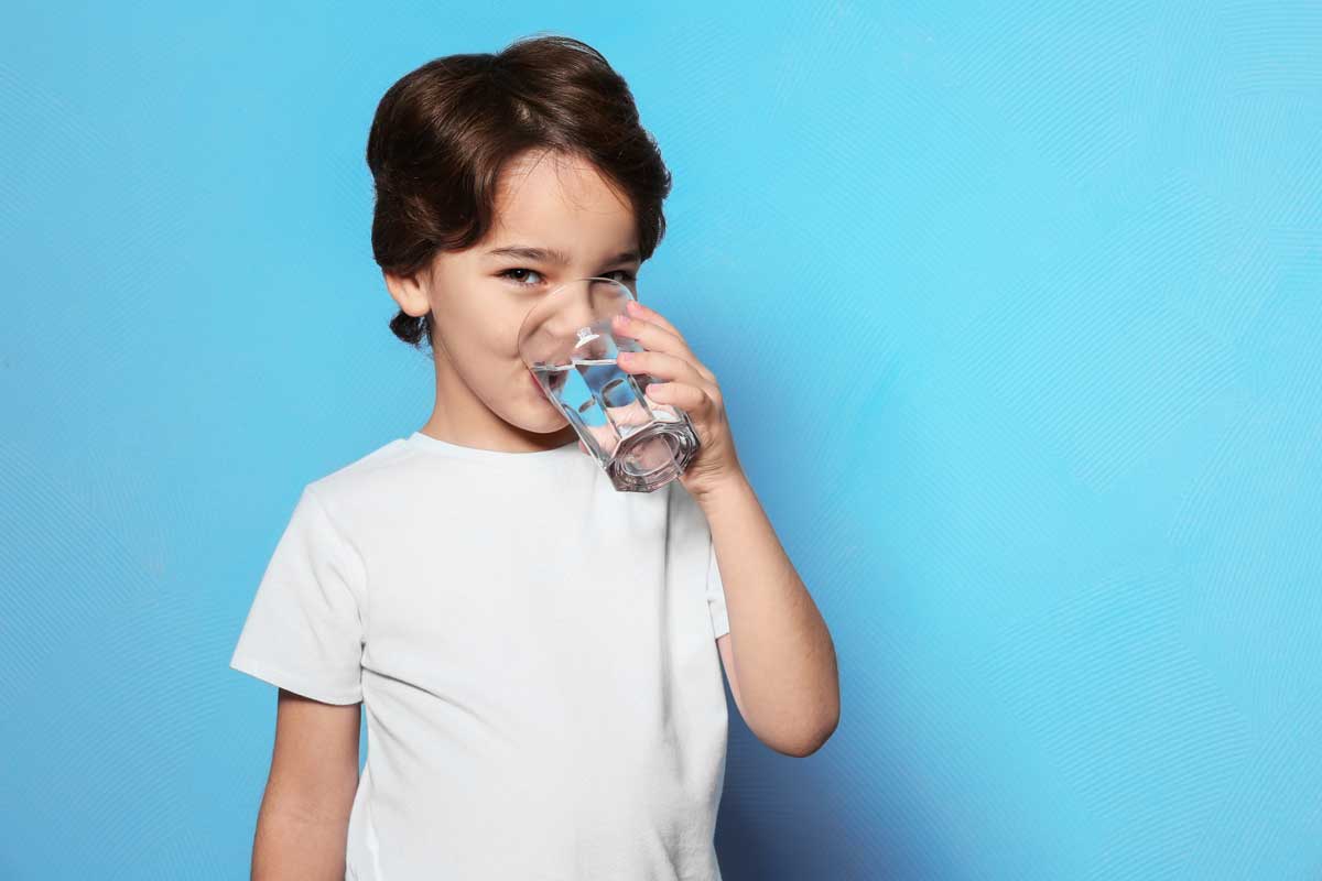child drinking water and smiling