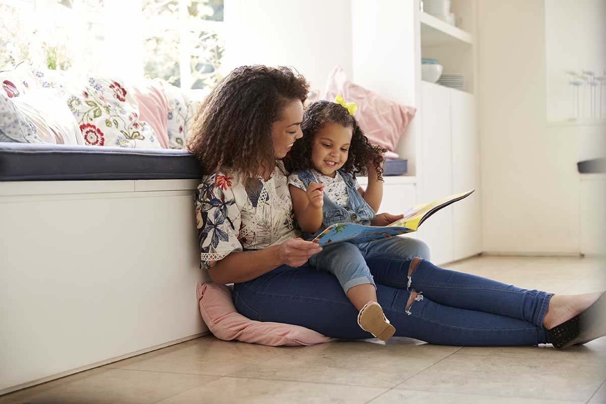 mom reading to her child laughing