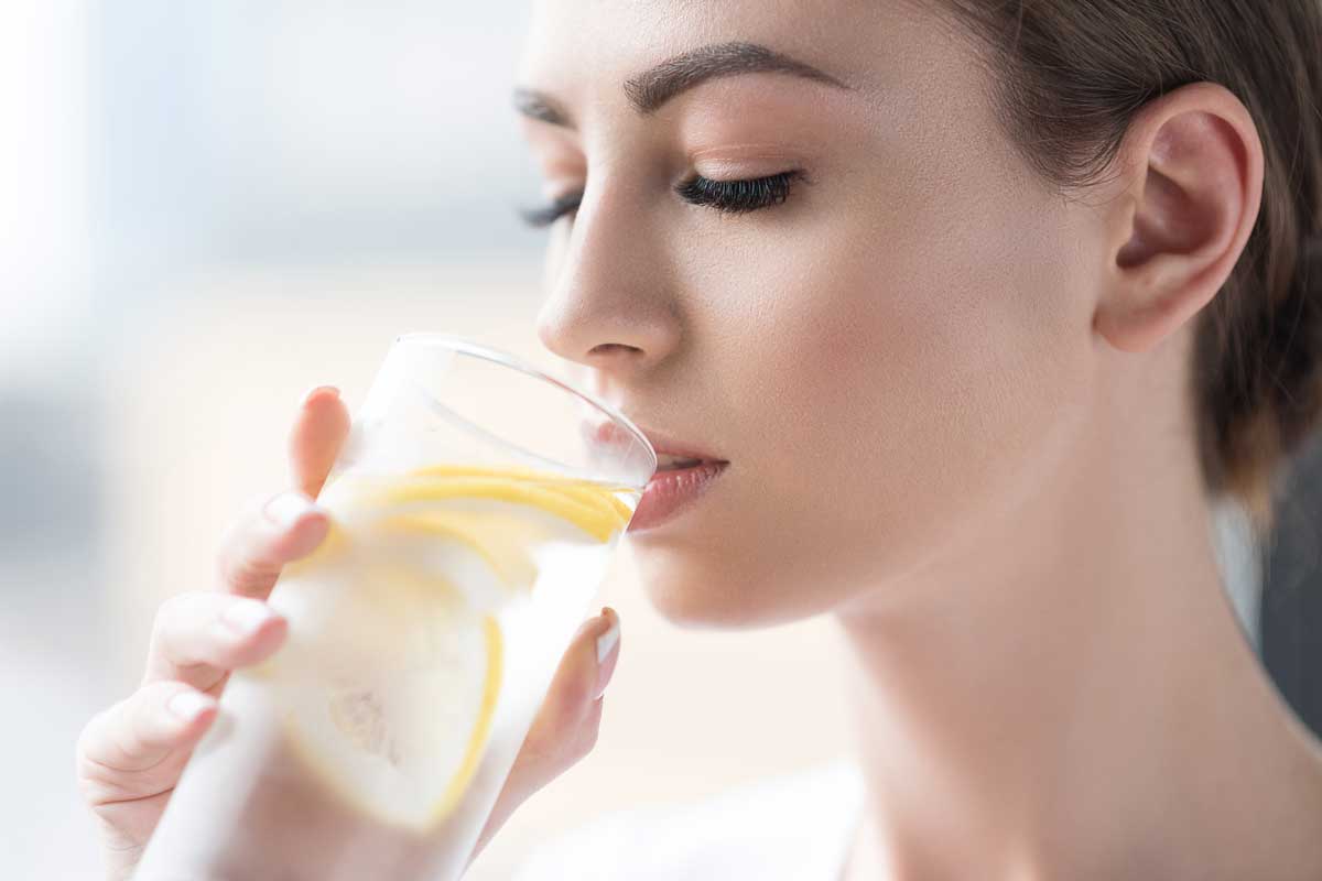 woman drinking lemon water