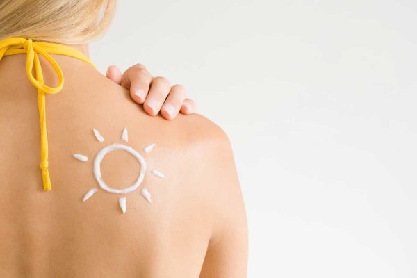 woman with sun shaped sunscreen on back