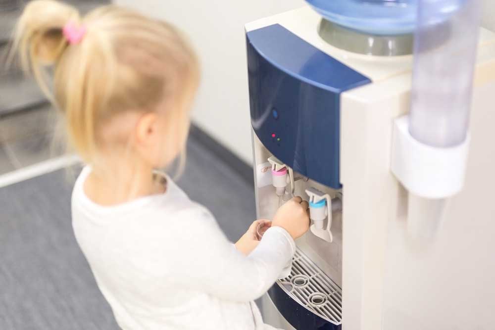 girl using the water cooler