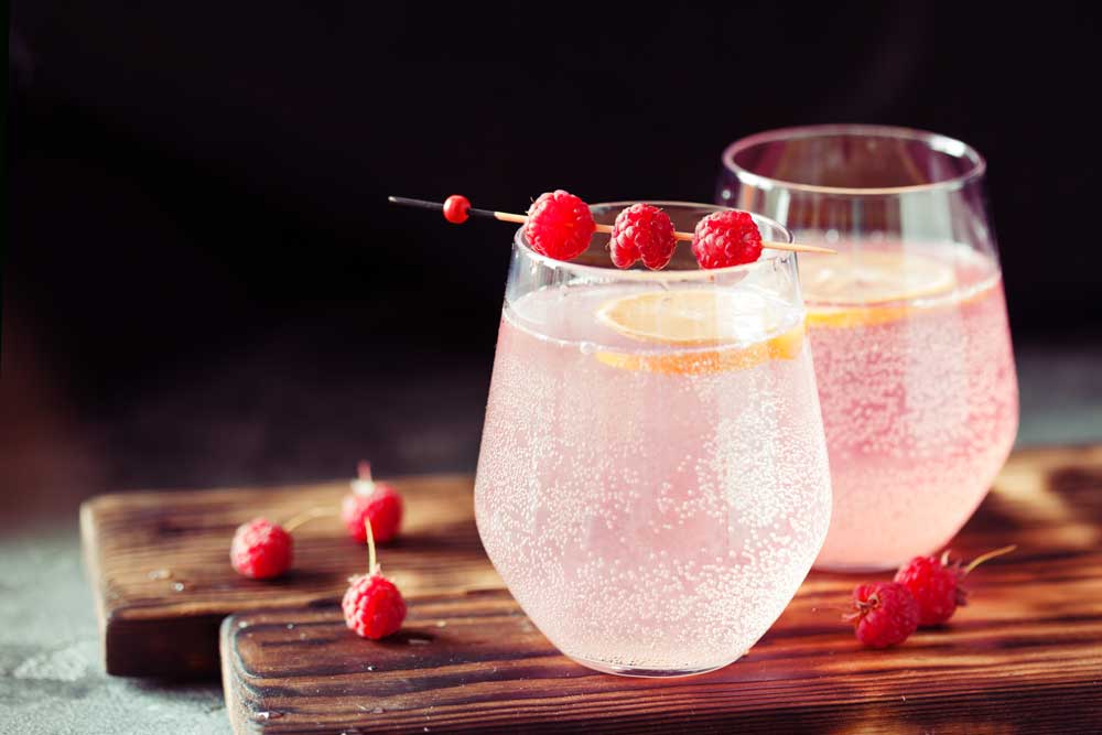 Berries and fruit in sparkling water to infuse flavor