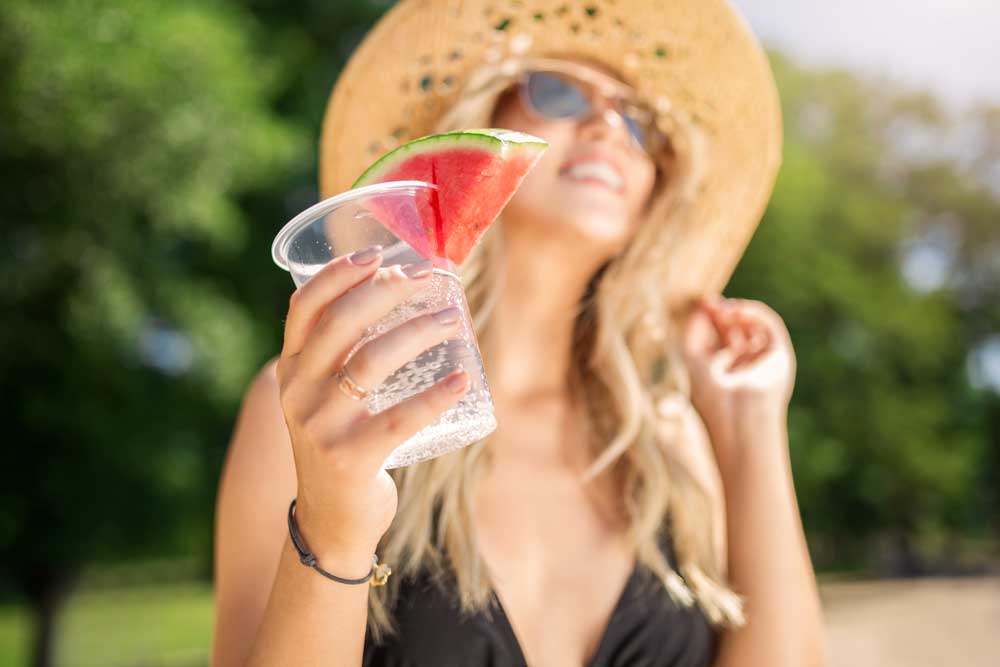girl drinking sparkling water in the summer